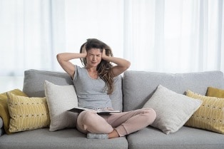 An image of a person dealing with a loud HVAC system.