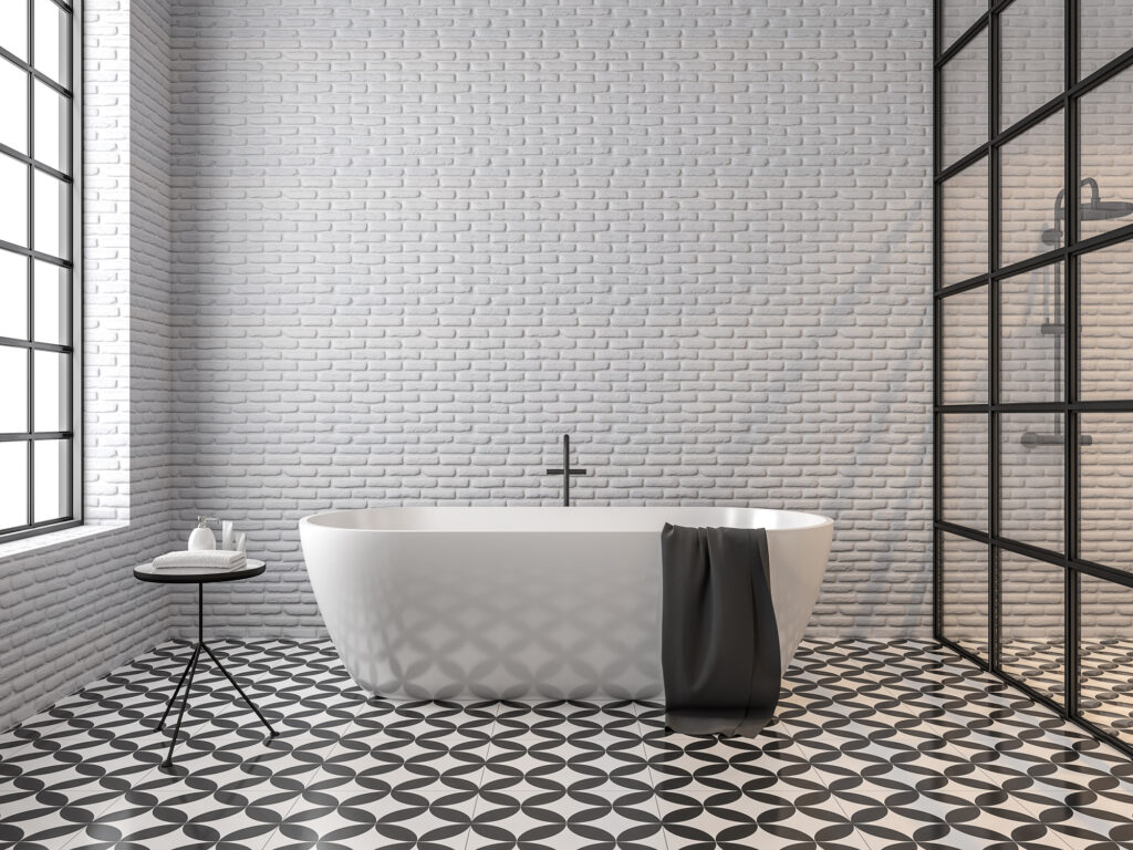 A modern bathroom with a beautiful bathtub, white-painted brick walls, and tiled floors.
